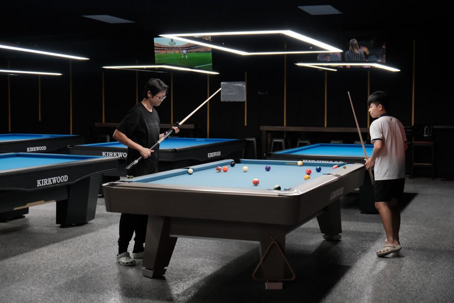 Group of players hanging out around table 5 during World Cup night