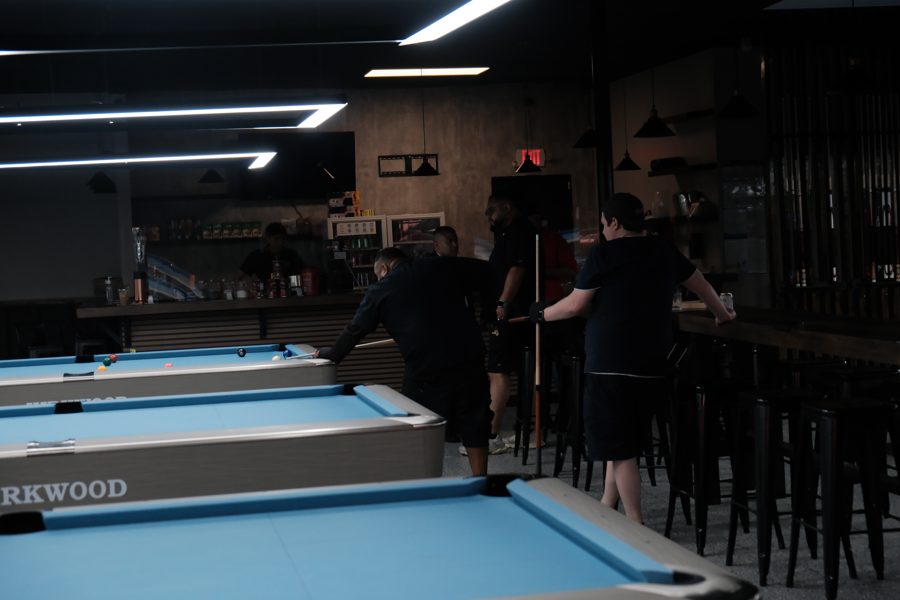 Player lining up a shot on table B3 during a busy night